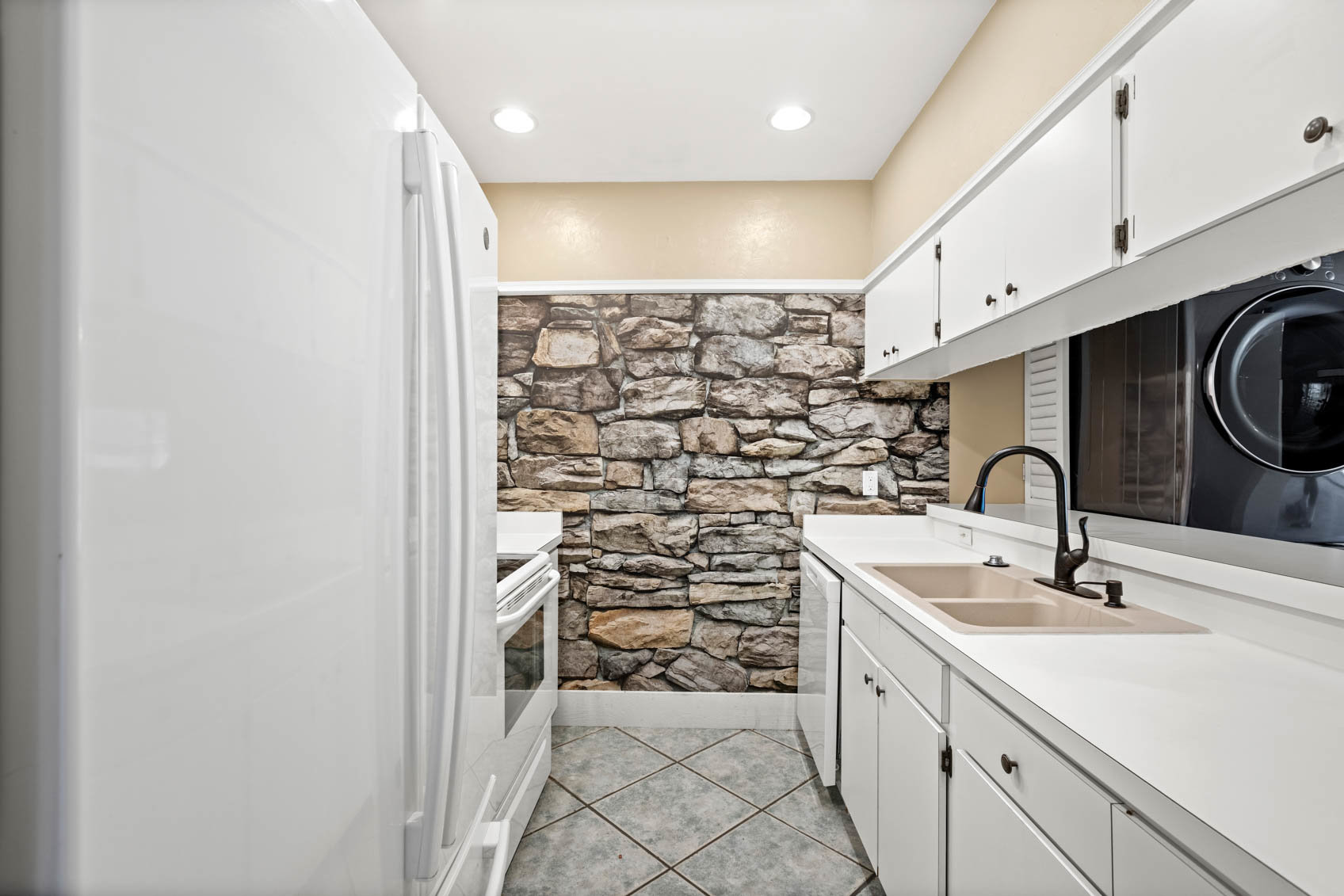 hallway kitchen with white cabinets